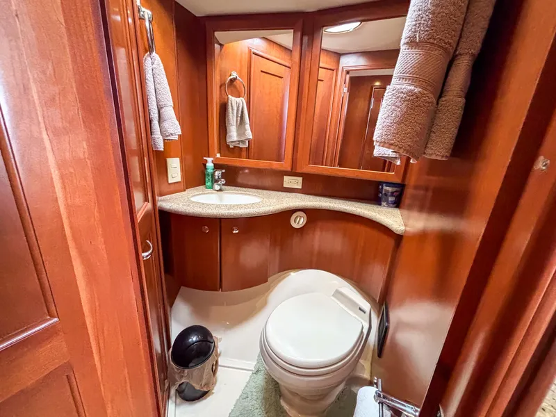 Slide: The Image of Luxurious 2007 Silverton 38 Convertible yacht bathroom with wood cabinetry and modern fixtures. - 24