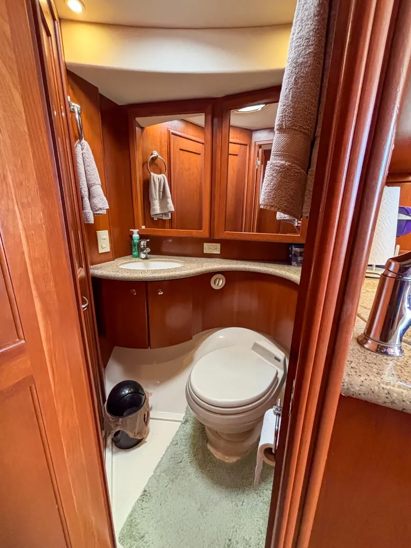 Slide: The Image of Luxurious bathroom in 2007 Silverton 38 Convertible yacht with wooden cabinetry and modern fixtures. - 25