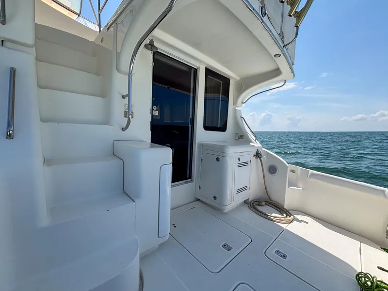 Slide: The Image of 2007 Silverton 38 Convertible yacht deck with stairs, ocean view, and storage compartments. - 5