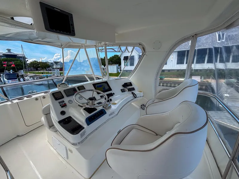 Slide: The Image of 2007 Silverton 38 Convertible yacht helm with dual seats and navigation controls. - 8