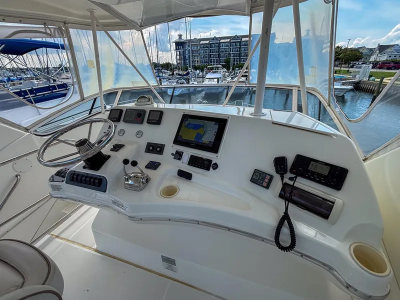 Slide: The Image of 2007 Silverton 38 Convertible yacht helm with navigation equipment and marina view. - 9