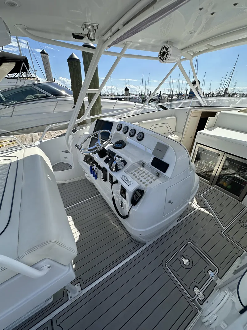 Slide: The Image of 2002 Intrepid 377 Walkaround Cuddy boat helm with modern controls and seating. - 33