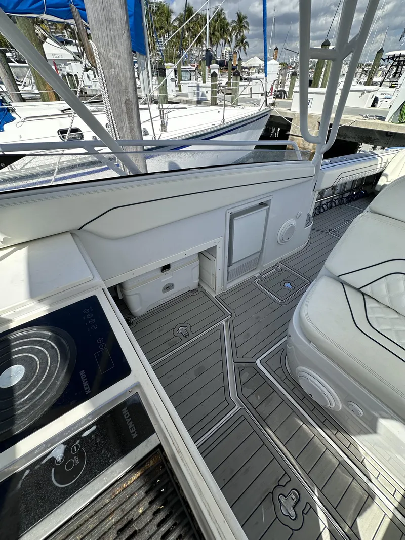 Slide: The Image of 2002 Intrepid 377 Walkaround Cuddy boat interior with modern deck and seating. - 42
