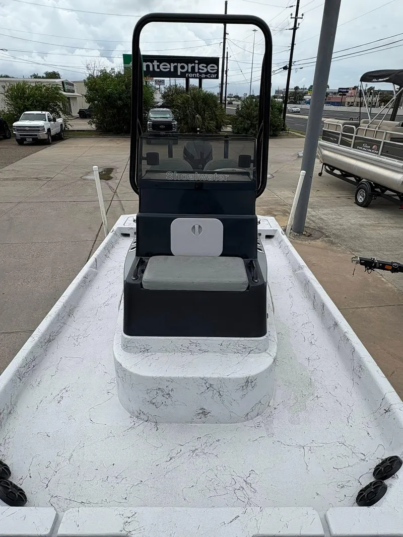Slide: The Image of 2022 Shoalwater 21 Catamaran boat with center console, parked outdoors. - 10