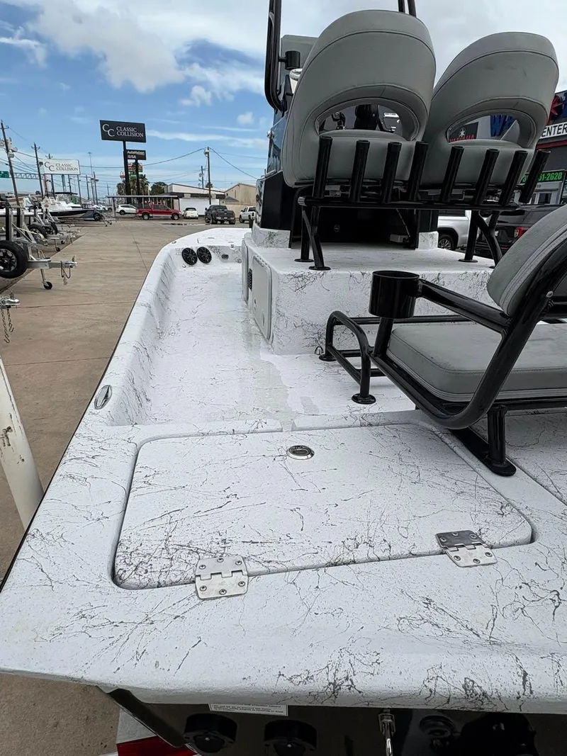 Slide: The Image of 2022 Shoalwater 21 Catamaran boat interior with seating and storage compartments. - 13