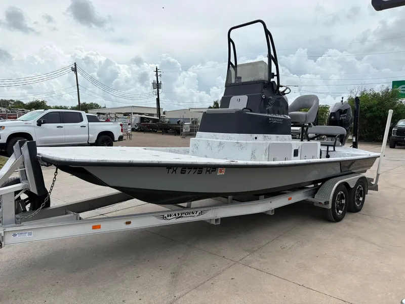 Slide: The Image of 2022 Shoalwater 21 Catamaran on trailer, parked outdoors, with overcast sky. - 15