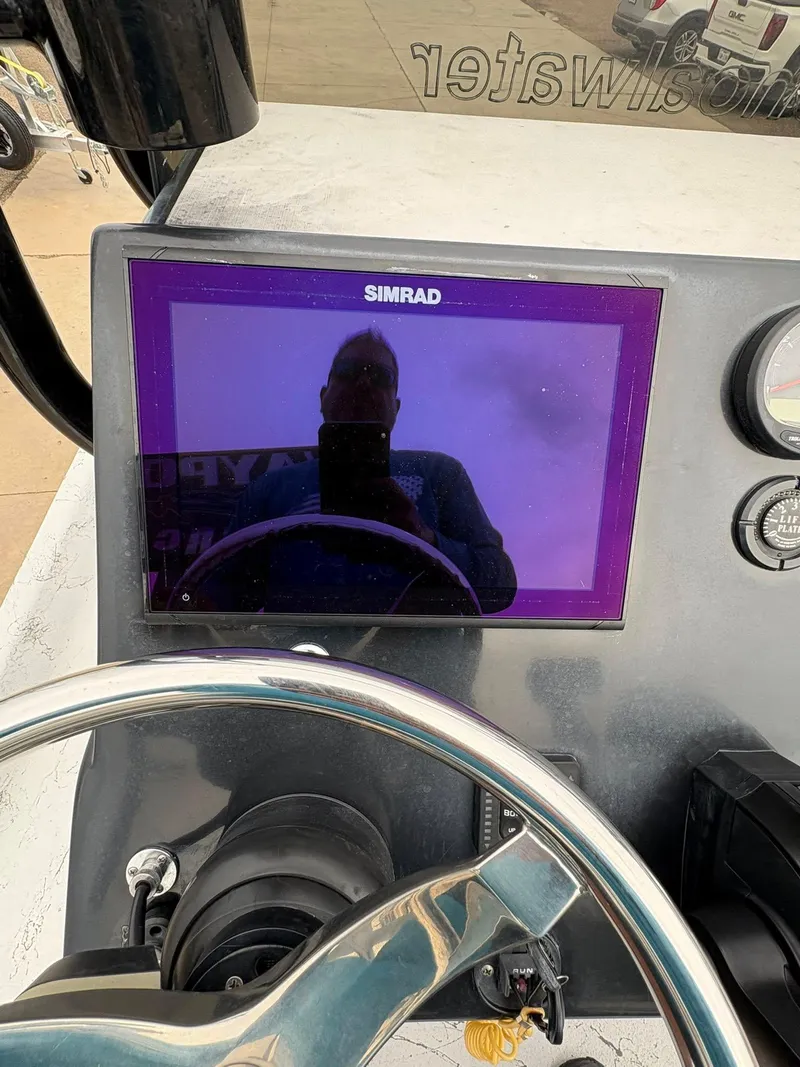 Slide: The Image of Dashboard of 2022 Shoalwater 21 Catamaran with Simrad display and steering wheel. - 18
