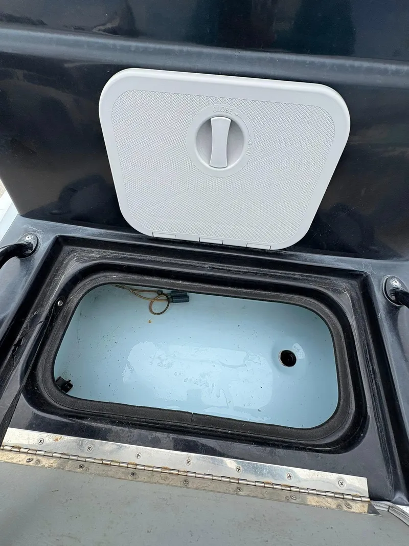 Slide: The Image of Open storage compartment on a 2022 Shoalwater 21 Catamaran boat. - 19