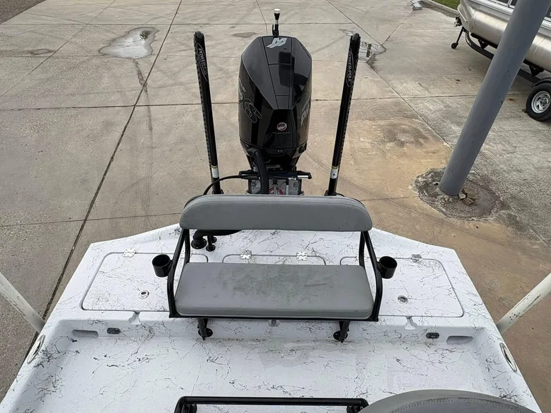 Slide: The Image of 2022 Shoalwater 21 Catamaran boat with motor and seating, parked on concrete surface. - 9