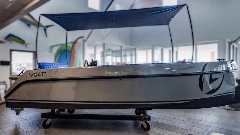 Slide: The Image of 2023 Vision Marine Technologies Volt 180 electric boat displayed indoors. - 2