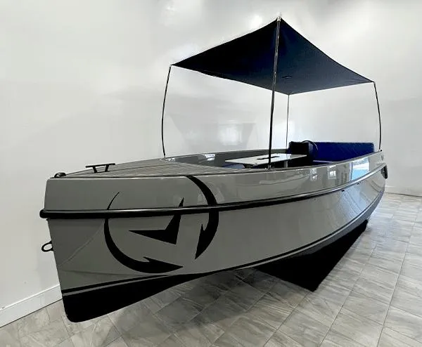 Slide: The Image of 2023 Vision Marine Technologies Volt 180 boat with canopy, displayed indoors. - 3