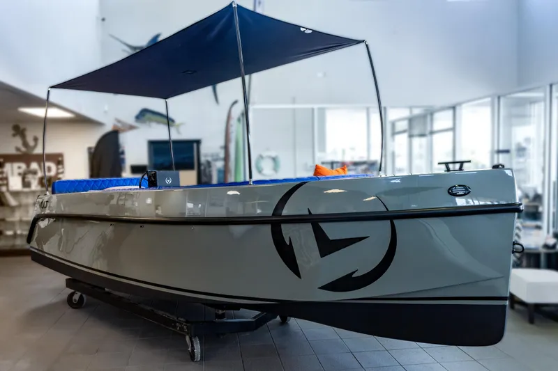 The Image of 2023 Vision Marine Technologies Volt 180 boat displayed indoors with canopy. - 0