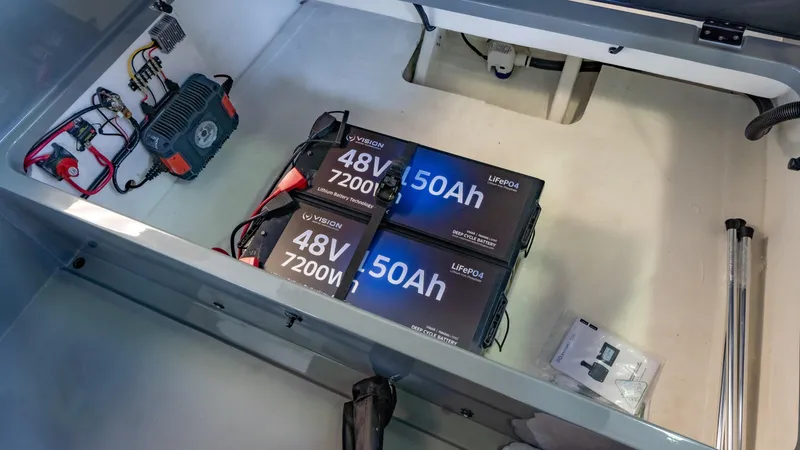 Slide: The Image of 2023 Vision Marine Technologies Volt 180 battery compartment with 48V 7200W LiFePO4 batteries. - 14