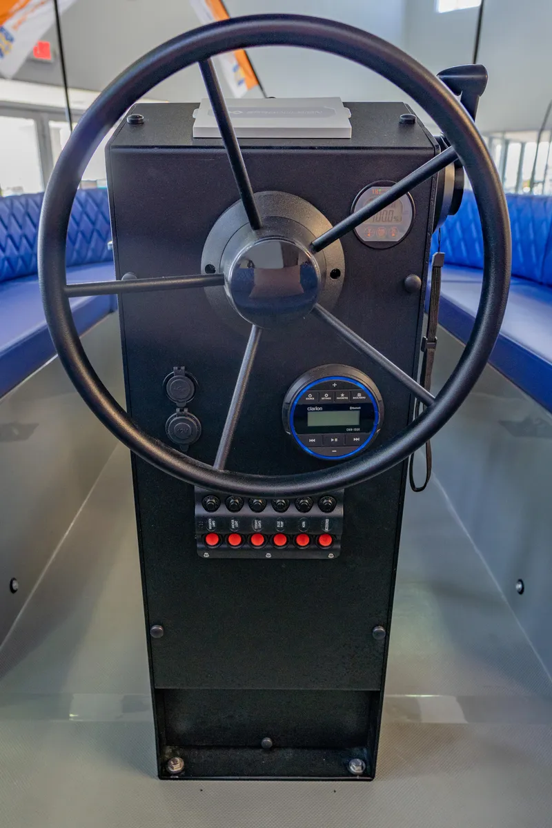 Slide: The Image of 2023 Vision Marine Technologies Volt 180 steering console with modern controls and blue seating. - 9