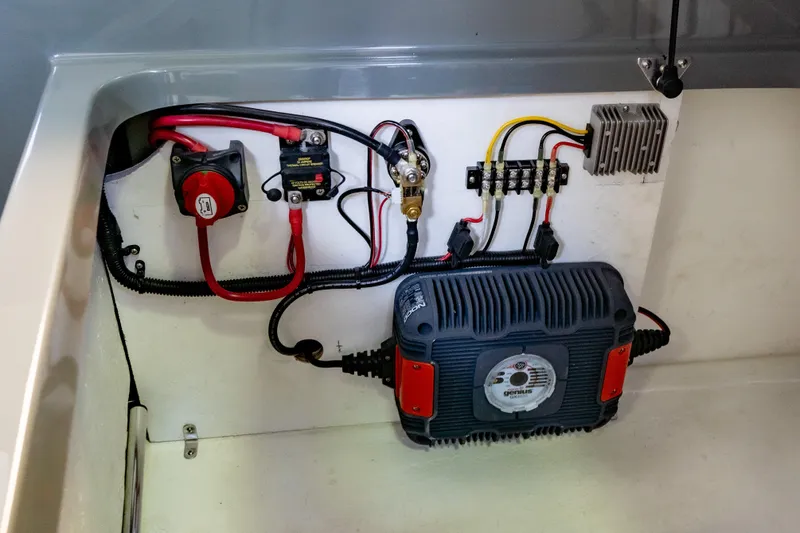 Slide: The Image of Electrical components inside 2023 Vision Marine Technologies Volt 180 boat. - 12