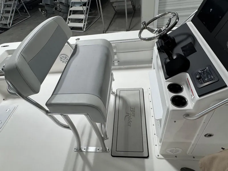 Slide: The Image of Bay Rider 2260 FS Skiff 2026 helm with steering wheel and seating in a boat interior. - 14