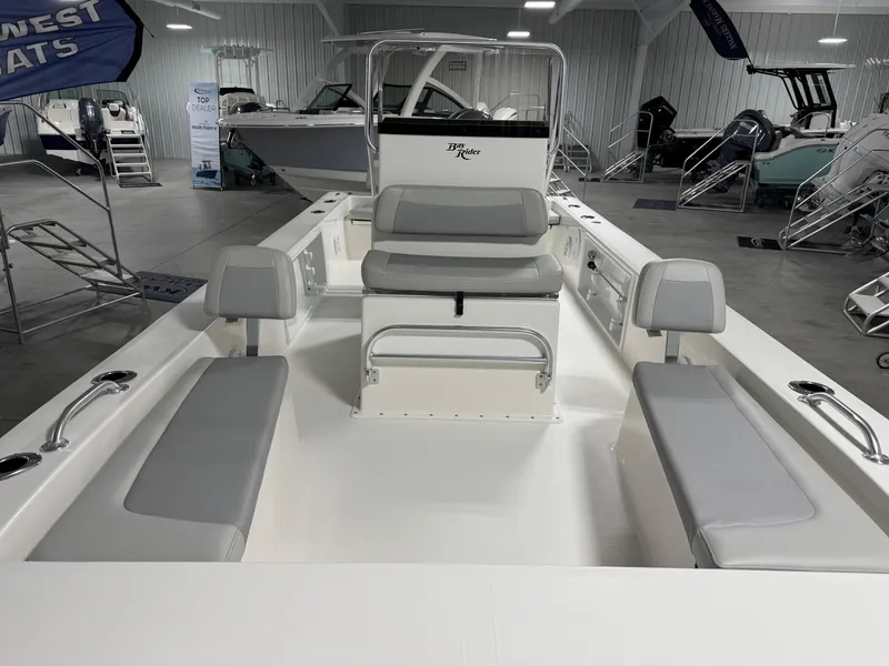 Slide: The Image of 2026 Bay Rider 2260 FS Skiff interior with gray seating in a showroom. - 5