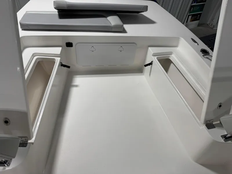 Slide: The Image of Bay Rider 2260 FS Skiff 2026 interior with storage compartments and cushioned seating. - 9
