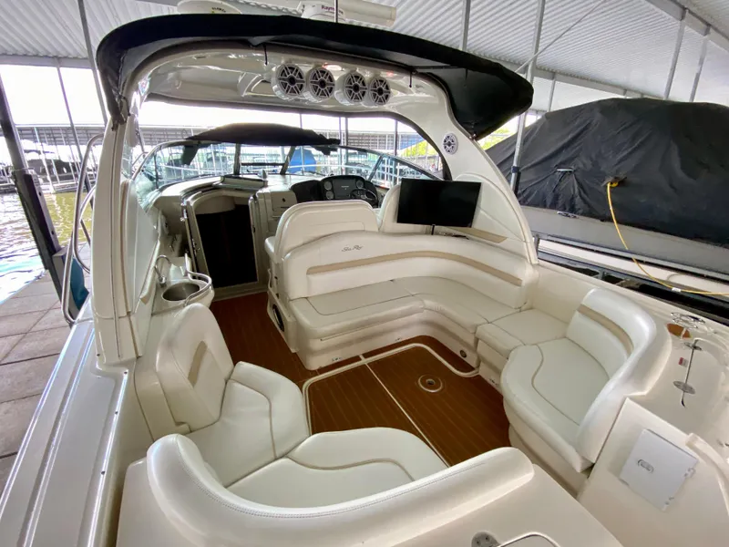 Slide: The Image of 2008 Sea Ray 38 Sundancer interior with white seating and wood flooring. - 10