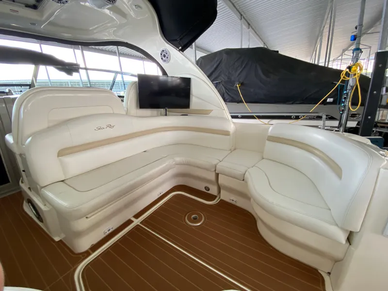 Slide: The Image of Luxurious interior of 2008 Sea Ray 38 Sundancer with white leather seating and wood flooring. - 11