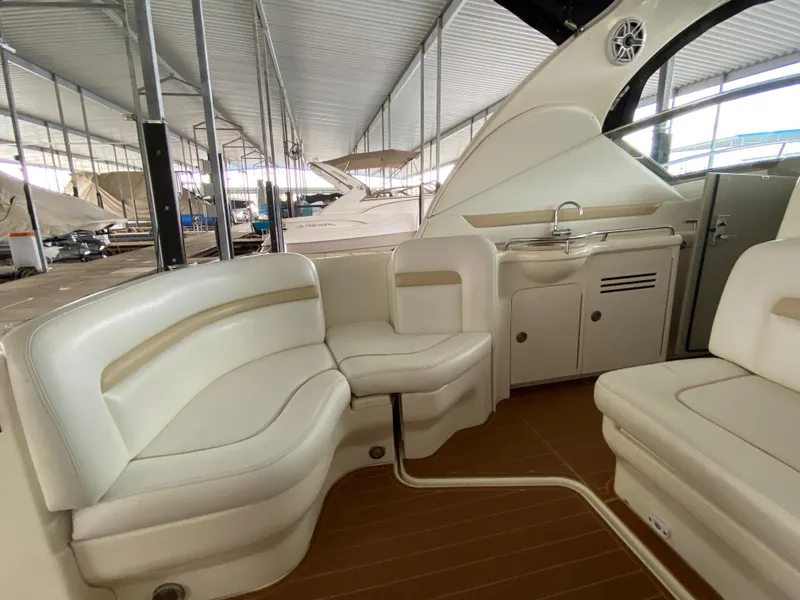 Slide: The Image of Interior of 2008 Sea Ray 38 Sundancer yacht with white seating and kitchenette. - 13