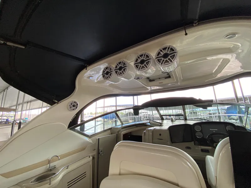 Slide: The Image of Interior view of 2008 Sea Ray 38 Sundancer yacht cockpit with speakers and dashboard. - 16