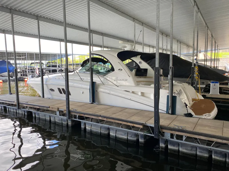 Slide: The Image of 2008 Sea Ray 38 Sundancer docked in a covered marina slip. - 2