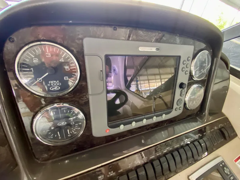 Slide: The Image of Dashboard of 2008 Sea Ray 38 Sundancer with gauges and navigation screen. - 20