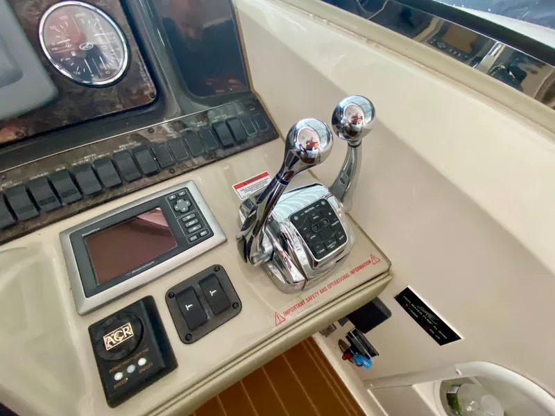 Slide: The Image of Control panel of 2008 Sea Ray 38 Sundancer with throttle levers and navigation display. - 21