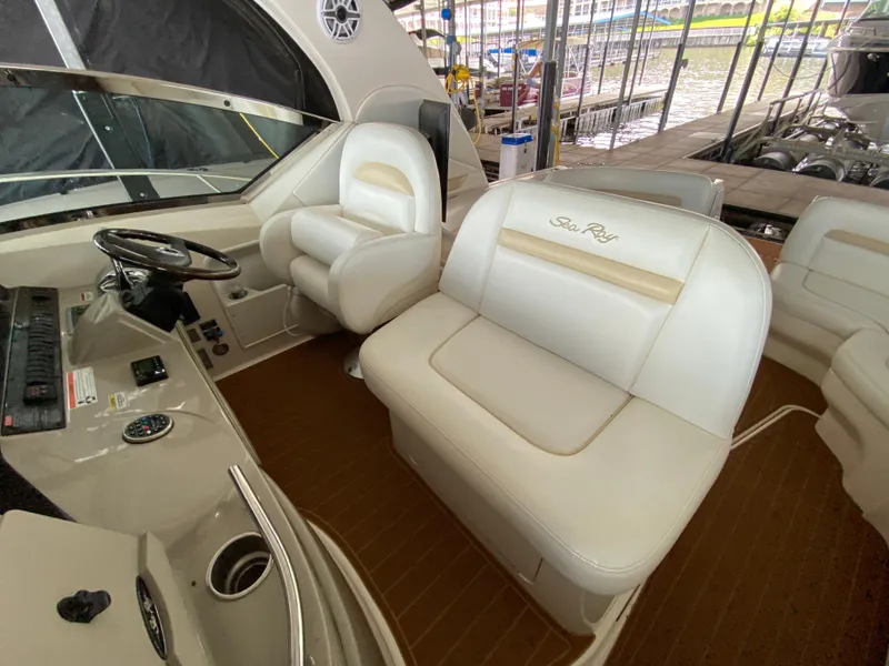 Slide: The Image of 2008 Sea Ray 38 Sundancer cockpit with white leather seating and steering wheel. - 24
