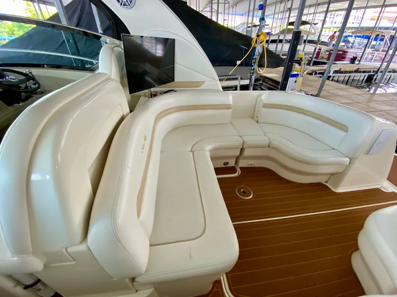 Slide: The Image of 2008 Sea Ray 38 Sundancer interior with white leather seating and wood flooring. - 26