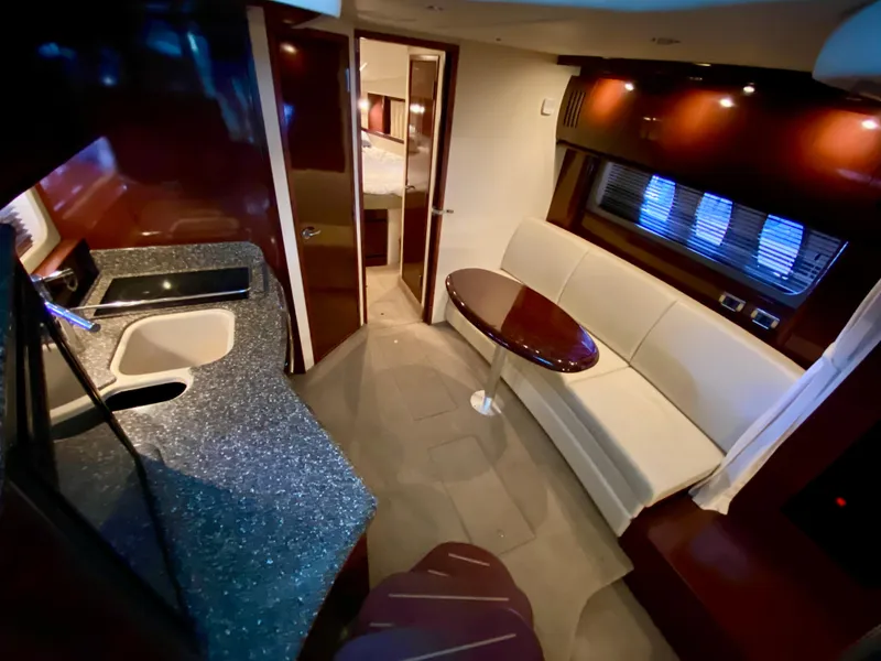 Slide: The Image of Luxurious interior of 2008 Sea Ray 38 Sundancer yacht with modern kitchen and seating area. - 27
