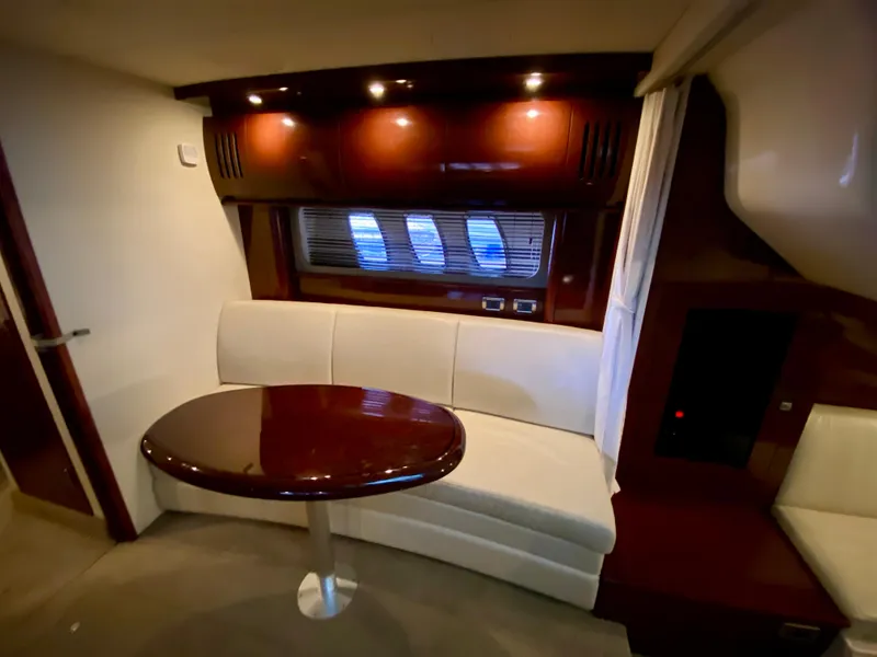 Slide: The Image of Luxurious interior of 2008 Sea Ray 38 Sundancer yacht with elegant seating and table. - 28