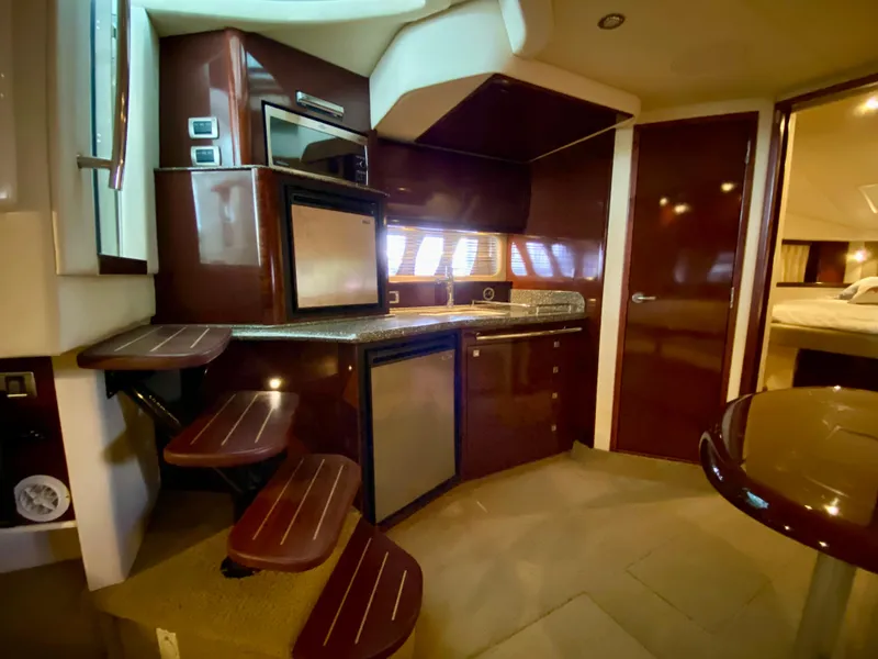 Slide: The Image of Interior of 2008 Sea Ray 38 Sundancer yacht with modern kitchen and wooden stairs. - 29