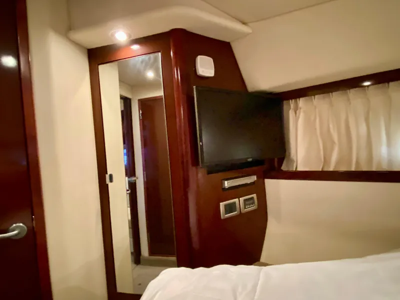 Slide: The Image of Interior of 2008 Sea Ray 38 Sundancer with TV, mirror, and wood paneling. - 32