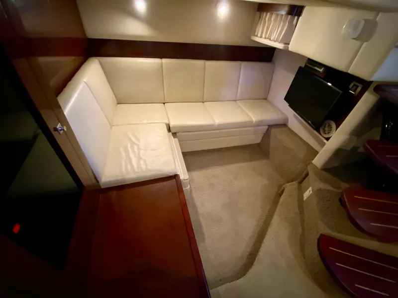 Slide: The Image of Luxurious interior of 2008 Sea Ray 38 Sundancer with cream leather seating and carpeted flooring. - 39