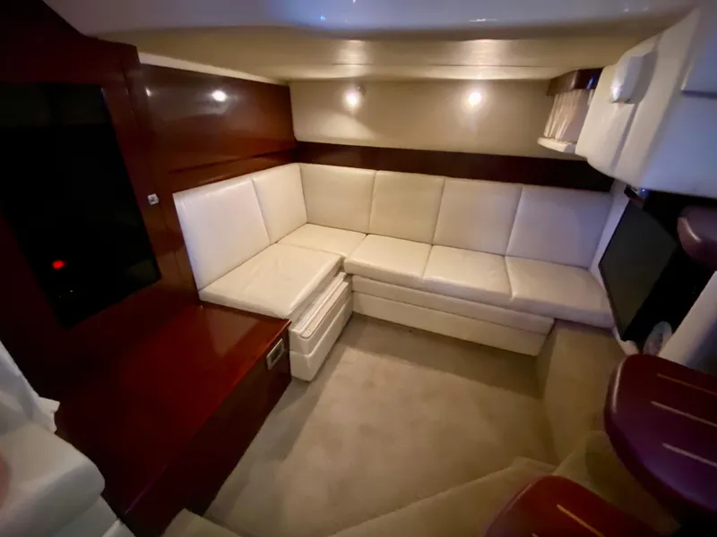 Slide: The Image of Interior of 2008 Sea Ray 38 Sundancer with white leather seating and wood accents. - 40