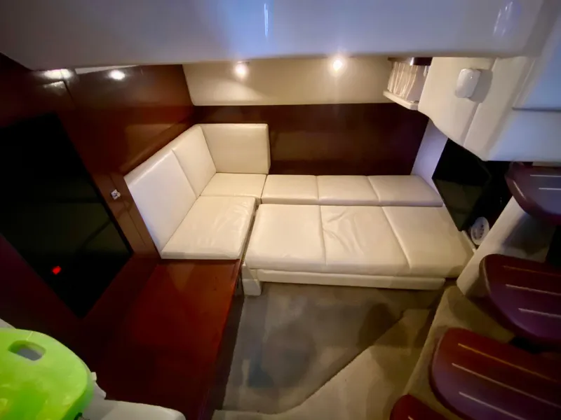 Slide: The Image of Interior of 2008 Sea Ray 38 Sundancer with cream leather seating and wooden accents. - 41