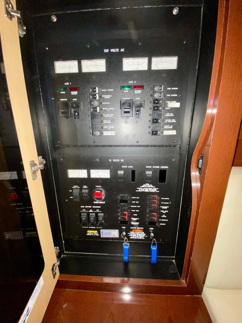 Slide: The Image of Electrical panel of 2008 Sea Ray 38 Sundancer boat, featuring AC and DC controls. - 43