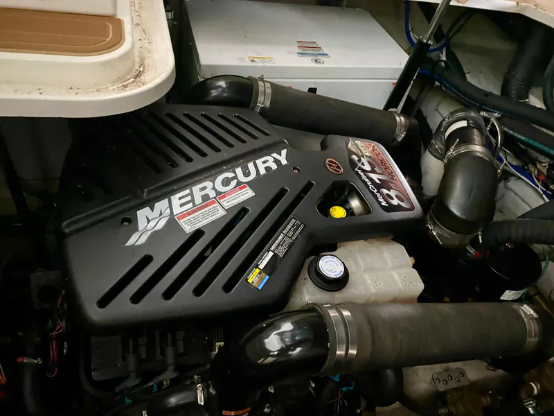 Slide: The Image of Mercury engine in 2008 Sea Ray 38 Sundancer boat, showcasing engine components and hoses. - 48