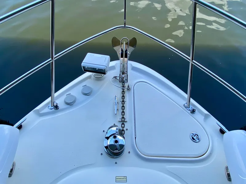 Slide: The Image of Bow of 2008 Sea Ray 38 Sundancer with anchor and railing, on calm water. - 9