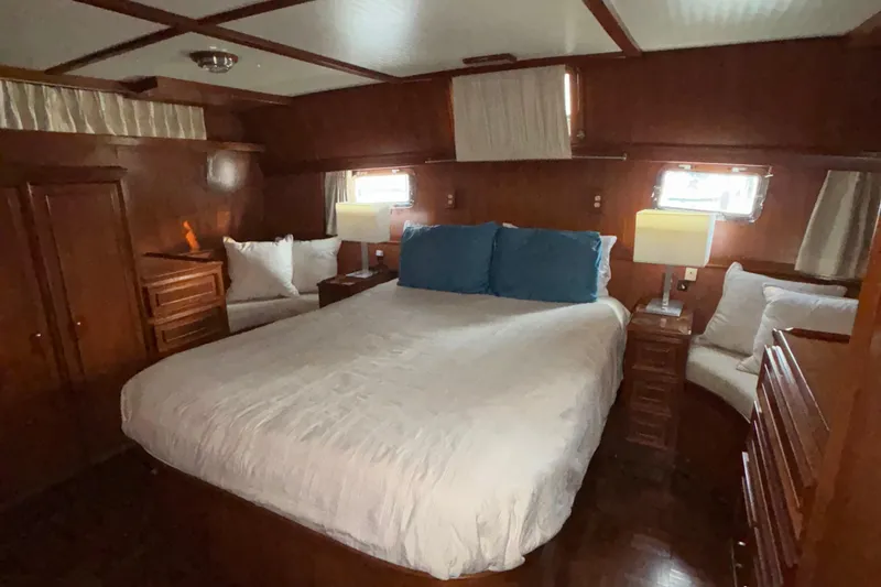 Slide: The Image of Luxurious bedroom interior of 1989 Jefferson 42 Sundeck Motor Yacht with wood paneling. - 14