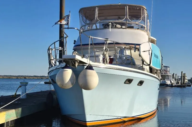 Slide: The Image of 1989 Jefferson 42 Sundeck Motor Yacht docked at marina, clear blue sky. - 1