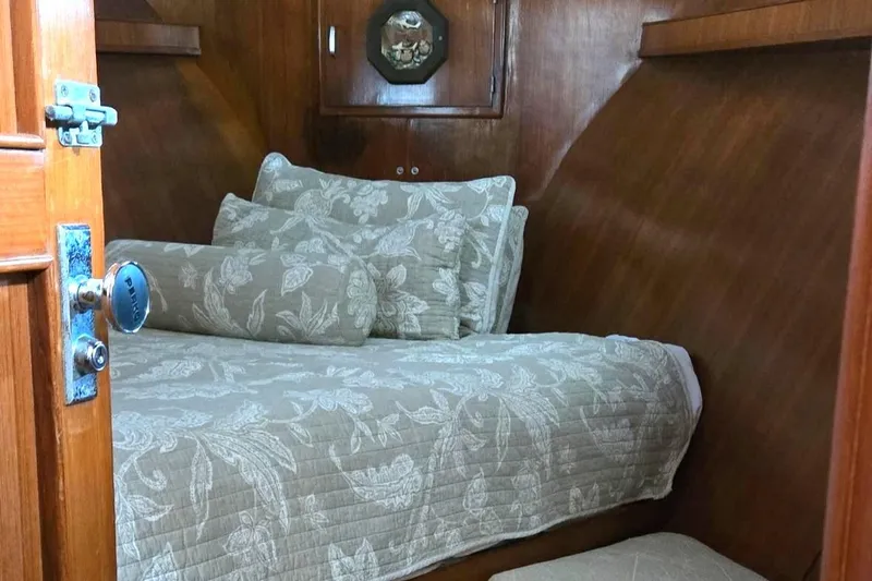 Slide: The Image of Cozy cabin interior of 1989 Jefferson 42 Sundeck Motor Yacht with floral bedding. - 11