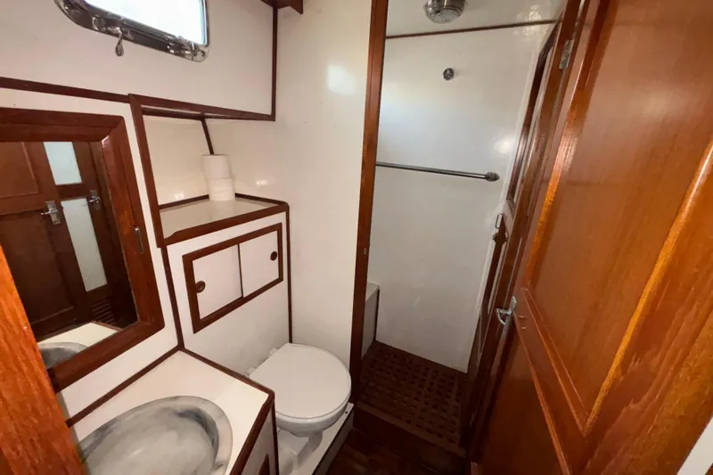 Slide: The Image of 1989 Jefferson 42 Sundeck Motor Yacht bathroom with wooden accents and compact design. - 12