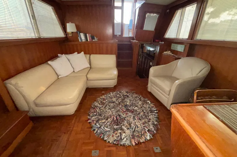 Slide: The Image of Cozy interior of 1989 Jefferson 42 Sundeck Motor Yacht with beige seating and decorative rug. - 13