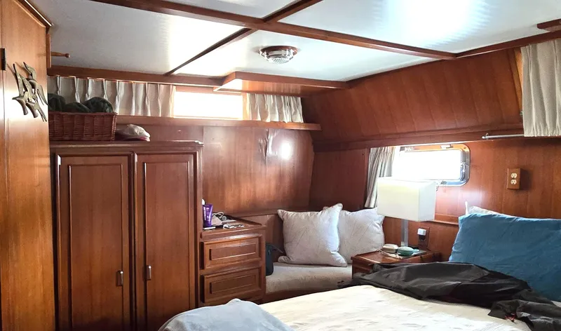 Slide: The Image of Cozy cabin interior of 1989 Jefferson 42 Sundeck Motor Yacht with wooden furnishings. - 16