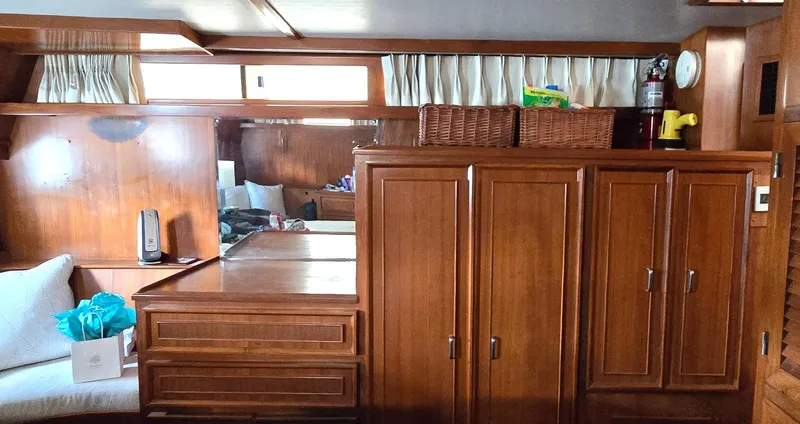 Slide: The Image of Interior of 1989 Jefferson 42 Sundeck Motor Yacht with wooden cabinetry and seating area. - 17