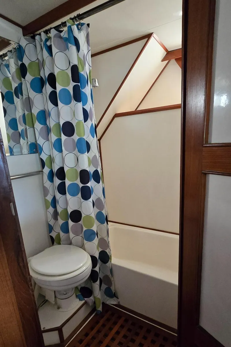 Slide: The Image of Bathroom in 1989 Jefferson 42 Sundeck Motor Yacht with colorful shower curtain. - 19