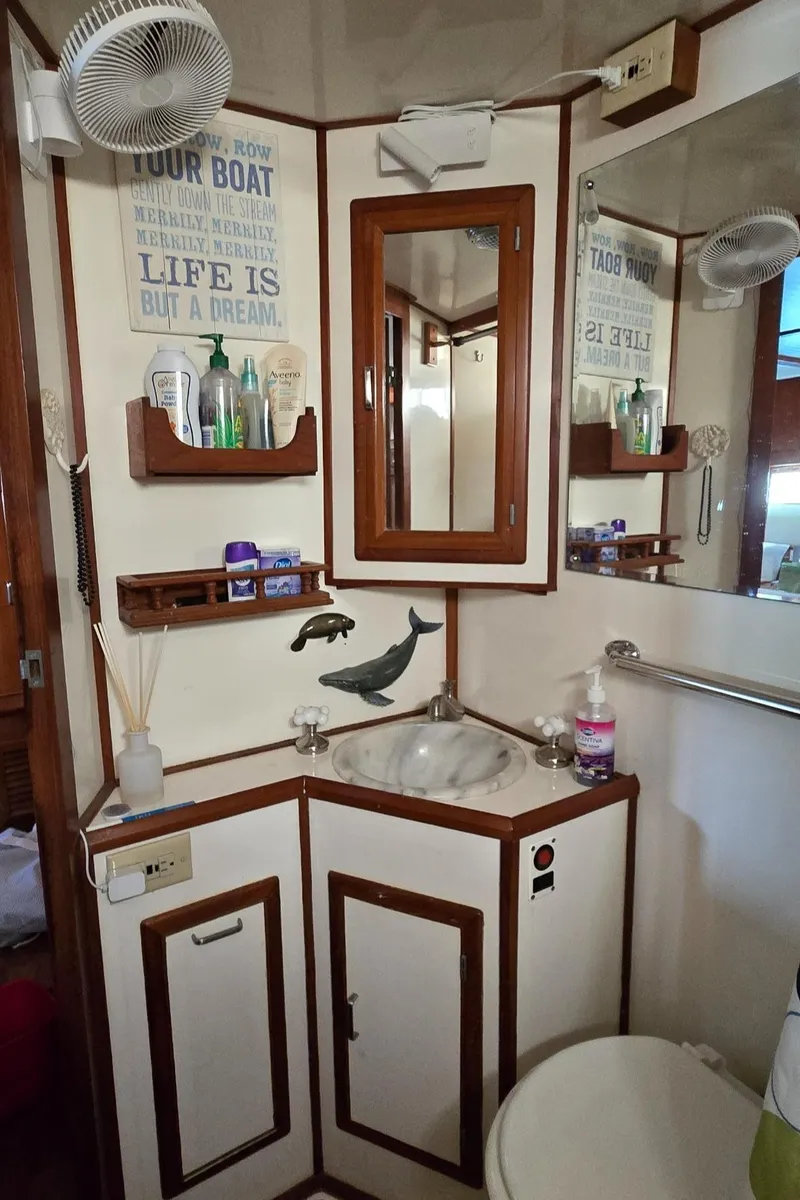 Slide: The Image of Bathroom interior of 1989 Jefferson 42 Sundeck Motor Yacht with wooden accents and nautical decor. - 20